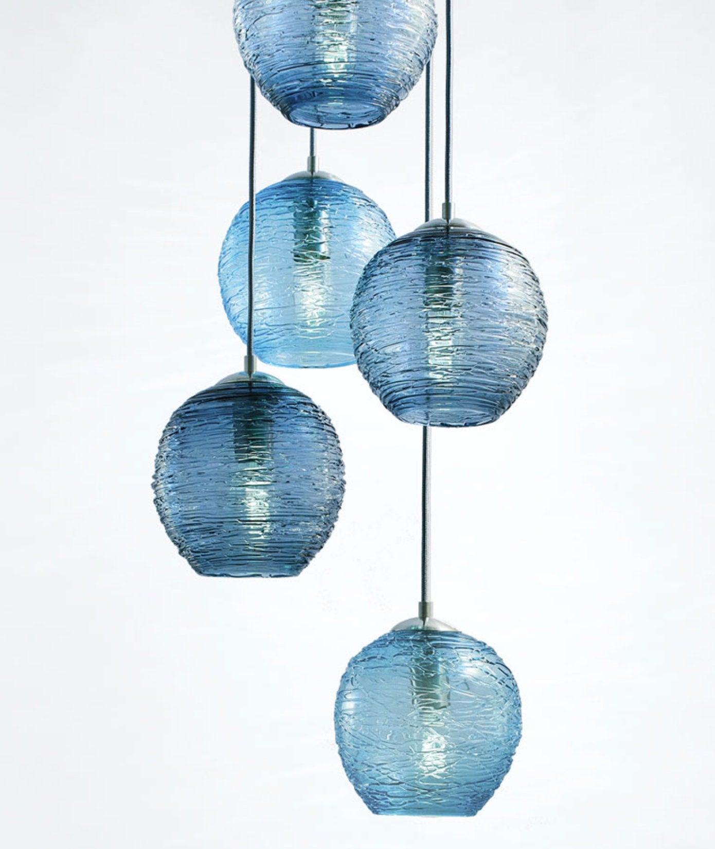 Cascading handblown glass luminaires in blue hanging pendant lights, perfect for stylish lighting decor.