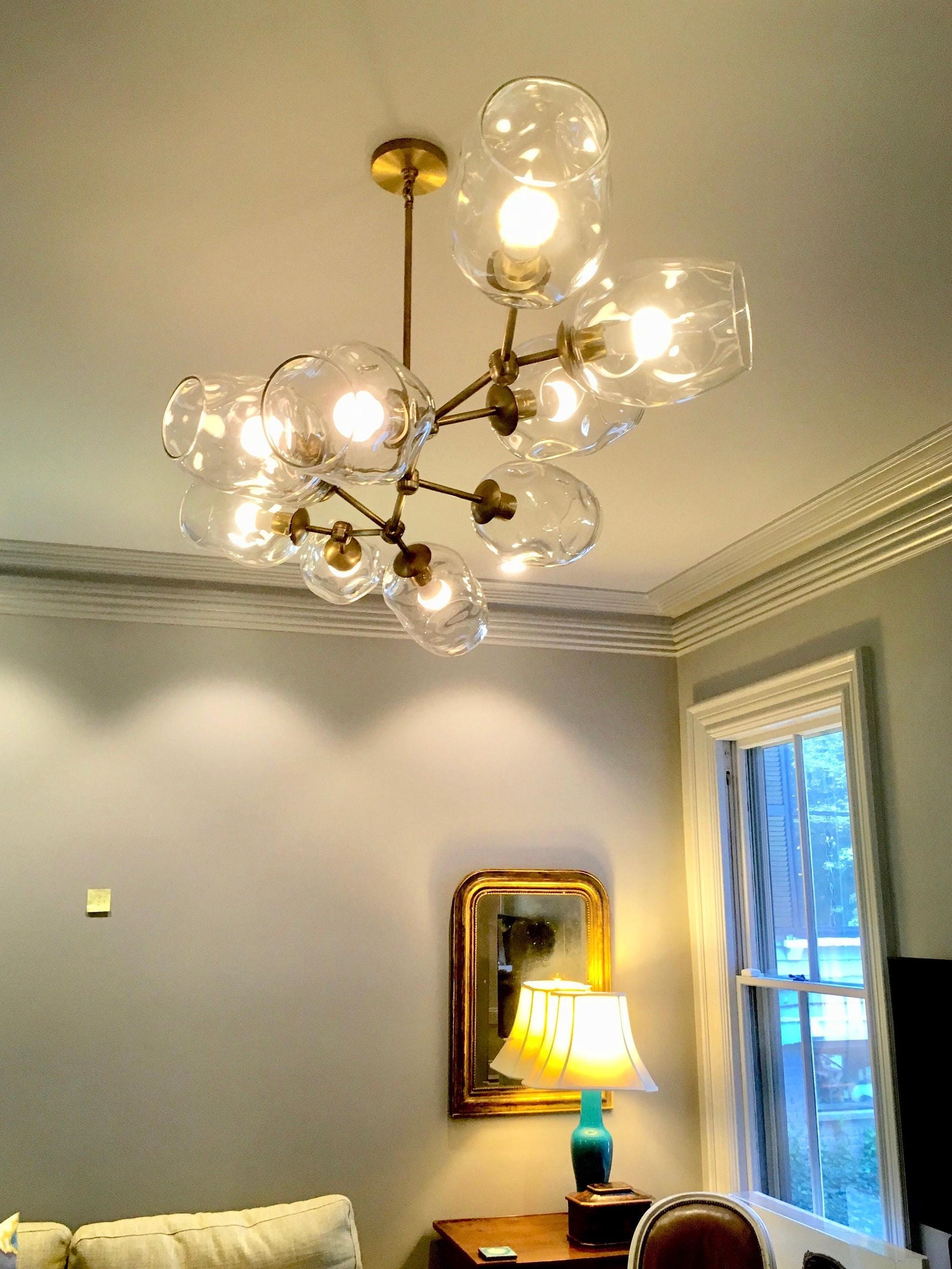 Petra Santina chandelier with handblown glass diffusers in a stylish living room setting.