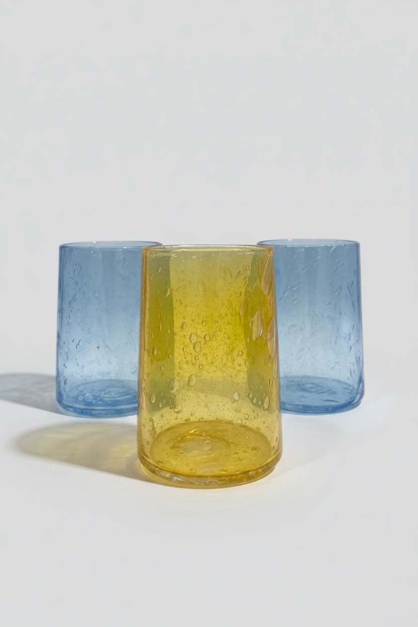 Blue and gold glass tumblers on a white background