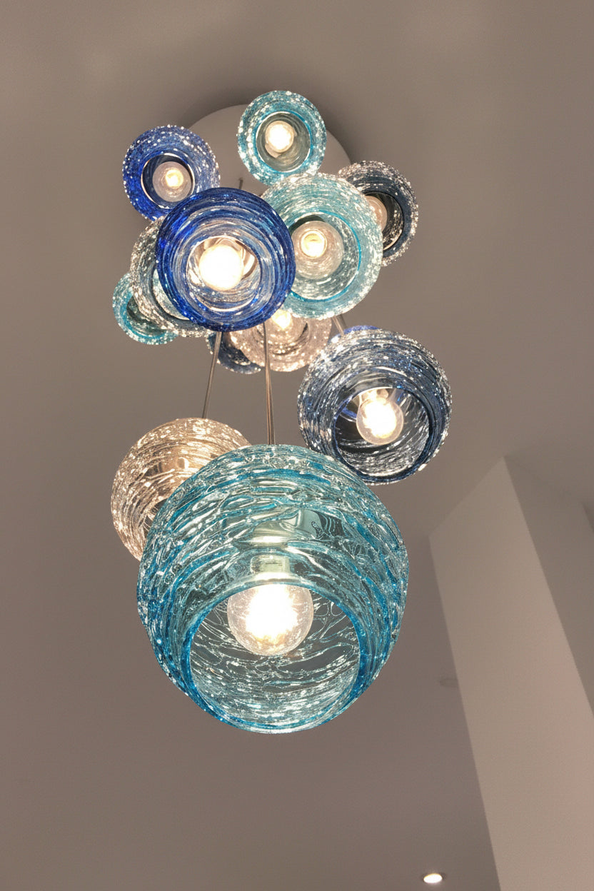 cascading chandelier with blown glass diffusers in clear and various blues.