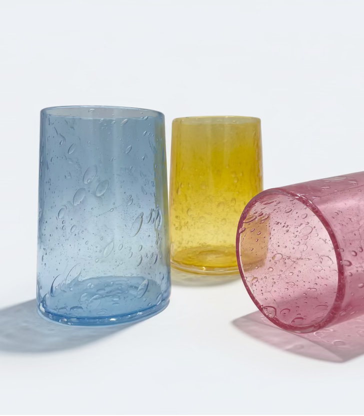 Three seeded glass tumblers on a white background