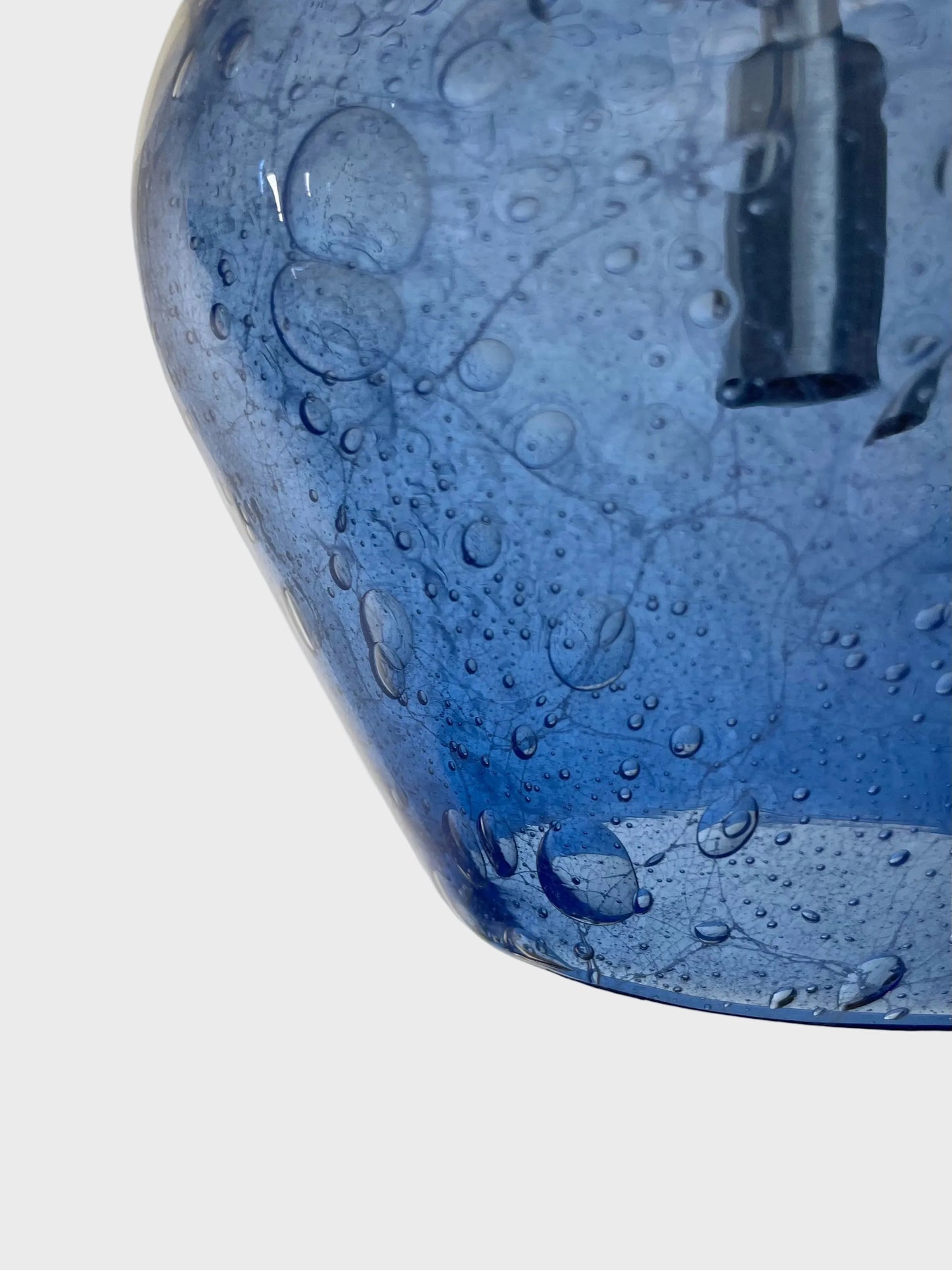 close up of a blue bubble glass pendant light