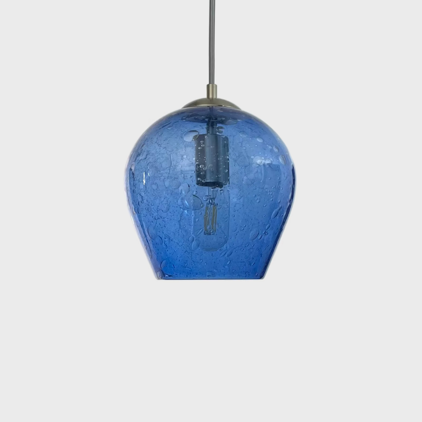 blue bubble glass pendant light on a white background