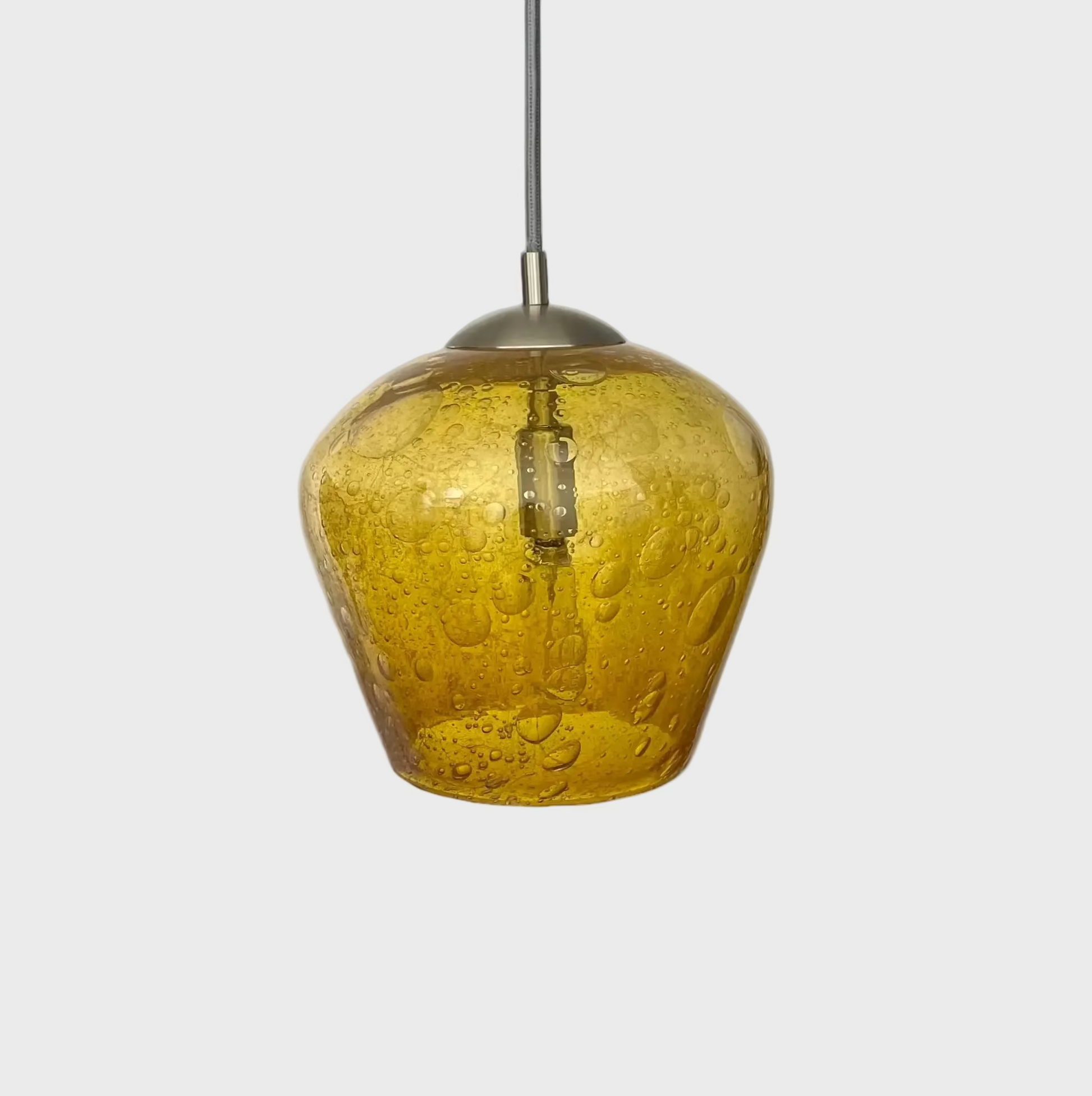 Gold bubble glass pendant light with brushed nickel hardware and silver cord on a white background