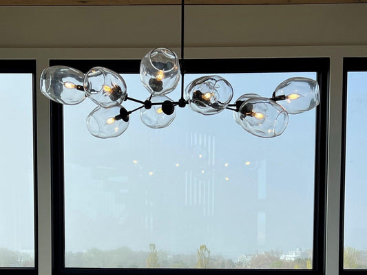 Petra Santina Chandelier featuring 8 handblown glass diffusers in a contemporary design, perfect for modern interiors.